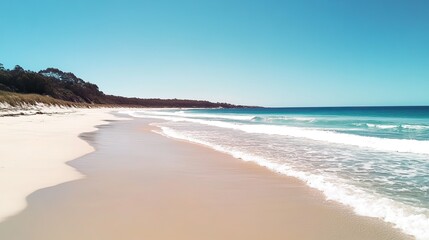 Obraz premium Serene Beach Landscape with Gentle Waves and Clear Blue Sky in a Relaxing Coastal Paradise Ideal for Vacation Destinations and Nature Escapes