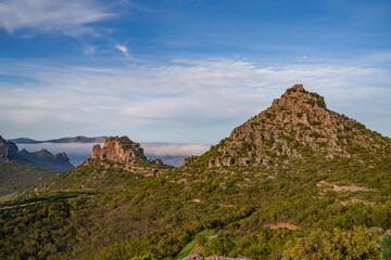 Beautiful view of the mountain panorama with fog rolling between the peaks