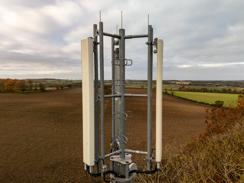Telecommunication tower providing signal coverage in rural landscape during autumn