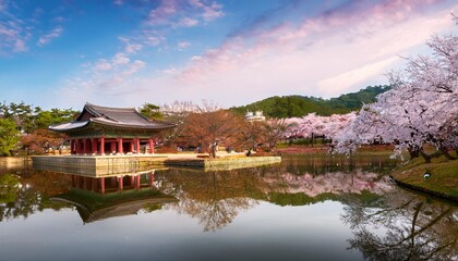 Fototapeta premium The Tranquil Beauty of Gyeongju’s Bulguksa Temple in South Korea, Surrounded by Cherry Blossom Trees in Full Bloom and a Serene Reflection Pond, Creating a Peaceful Historical Landscape