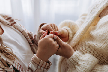 Mother and child holding hands, a warm connection of love, care, and trust