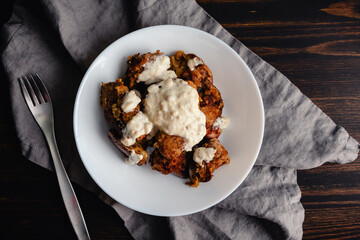 Southern Fried Chicken Livers with White Gravy: Breaded and fried chicken livers covered in peppered white gravy