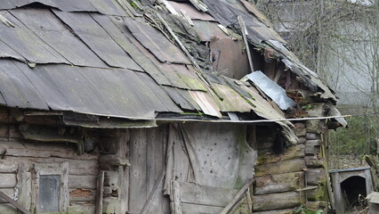 A hole in the roof of a wooden structure, house, barn, which has blown through from time, exposure...