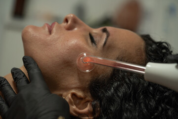 relaxed while undergoing facial frequency treatment