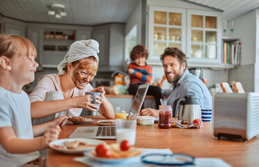 Happy family enjoying breakfast together in kitchen