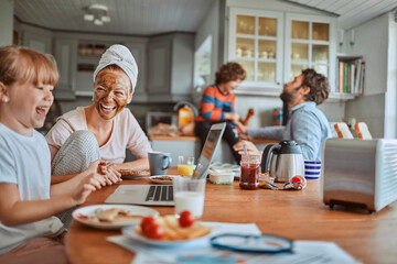 Happy family enjoying breakfast together in kitchen