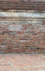 Old Orange brick and cement wall in Ayutthaya Thailand