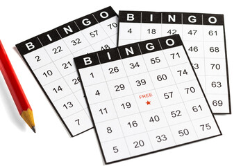 black and white paper bingo cards with a pencil on white background.