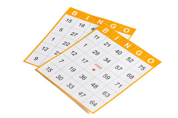 yellow and white paper bingo cards with a pencil on white background.