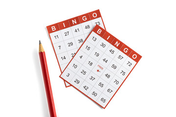 red and white paper bingo cards with a pencil on white background.