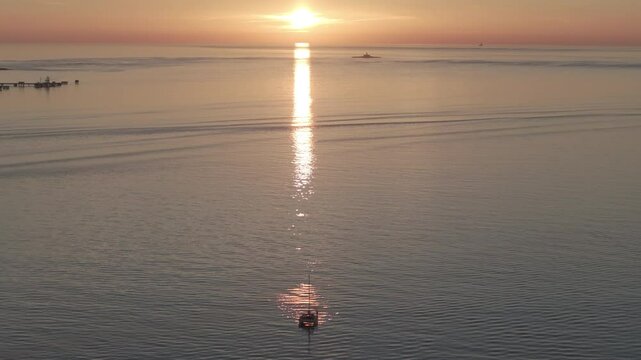 Aerial drone shot of the Forte do Bugio lighthouse, Tagus river, Atlantic Ocean and horizon at sunset from Lisbon, Portugal, Europe. Shot in ProRes 422 HQ