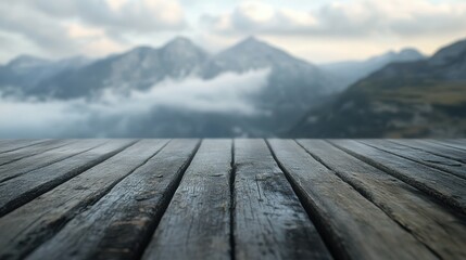 Serene view of an empty wooden table overlooking majestic mountains and cloudy sky