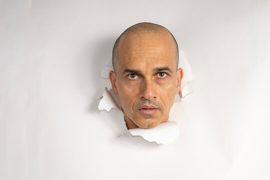 48 year old Brazilian man in casual clothes, only his head on a torn cardboard, showing emotions_1.