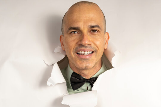 48 year old man in casual clothing and a bow tie, with only his head on a cardboard, showing emotions_1.