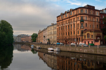 View of a residential building on the Moika River embankment on a sunny day, Saint Petersburg, Russia