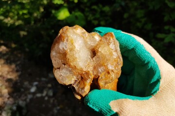 Rock crystal druse with large quartz crystals found in a ravine, rockhounding, field photo. Russia