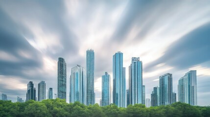 Fototapeta premium Skyline of skyscrapers under cloudy skies, buildings reflecting the sky in a soft blur, with trees at the base blending into the foreground, city banner,