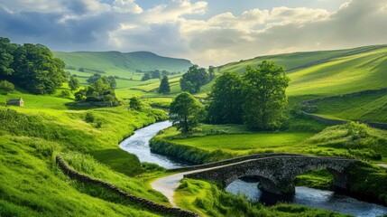 Obraz premium A picturesque view of a serene countryside landscape with rolling green hills, a winding river, and a small stone bridge