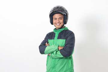Portrait of Asian online taxi driver wearing green jacket and helmet, standing with crossed arms....