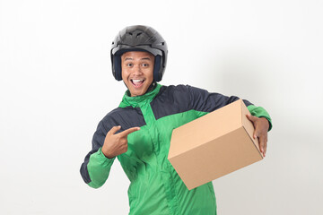 Portrait of Asian online courier driver wearing green jacket and helmet delivering package and box...