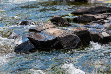 rocks and flowing water in the autumn stream
