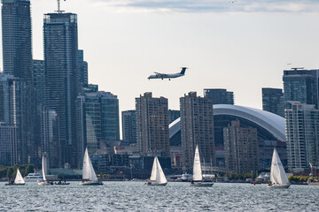 Fototapeta premium Plane landing at Billy Bishop Toronto City Airport on Lake Ontario. Toronto, Canada - August 22, 2024.