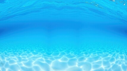 Underwater panoramic view of a blue ocean with water waves, sandy sea bottom, and isolated white background, sea bottom, isolated