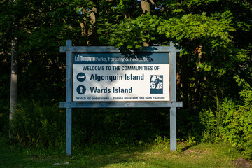 Fototapeta premium Signs for Algonquin Island and Wards Island in the Toronto Islands. Toronto, Canada - August 22, 2024.