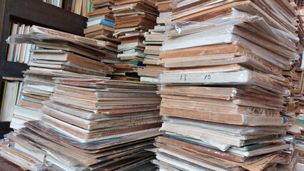The pile of old books in a traditional bookstore gives a vintage impression and acts as a window to the world.