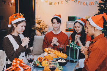 Group of young Asian man and women as friends having fun at a New Year's celebration, holding gift...