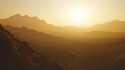 Fototapeta premium A serene sunset over mountains, casting warm hues across the landscape.