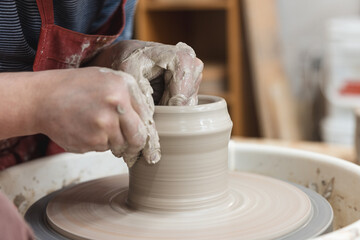Fototapeta premium Potter turning ceramics on a wheel