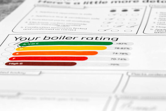 Customer household boiler rating on a service inspection document. Cost of living energy efficiency concept