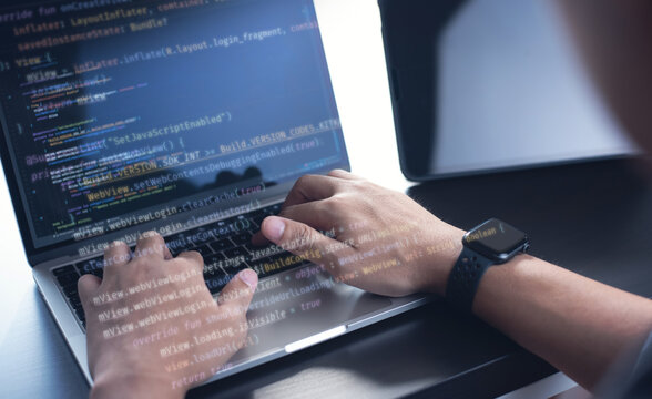 Computer programmer, software engineer typing, coding javascript on laptop computer, software development concept. Website design and coding technology