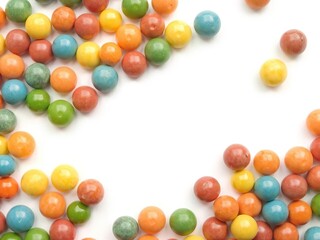 Fototapeta premium A close-up photo of colorful skittles isolated on a white background, treat