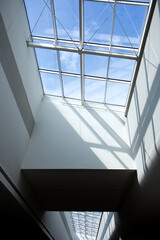 Fototapeta premium Building. Glass ceiling in a large building. Sun rays through a glass window. Light and shadow.