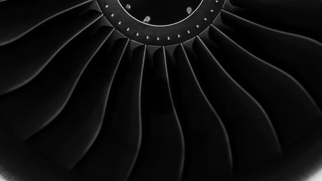 Jet engine against a black background, showcasing the spinning details of the aircraft's turbojet, highlighting its power and precision. Perfect for any aviation, engineering or aerospace technology.