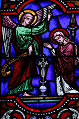 Obraz premium Saint Ferreol church. Stained glass window. The Annunciation by the angel Gabriel to the Virgin Mary. Saint Fargeau. France.