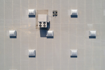 A white roof with a vent on top and a fan on the roof