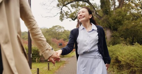 Holding hands, running and love with Japanese couple in park for trust, partner and bonding together. Commitment, freedom and happy with asian man and woman on date for care, honeymoon and vacation