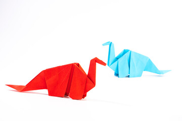Paper dinosaur on white background. paper crafts. origami dinosaur. origami art. © Denis