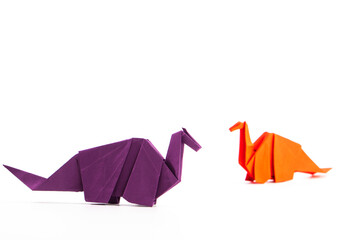Paper dinosaur on white background. paper crafts. origami dinosaur. origami art. © Denis