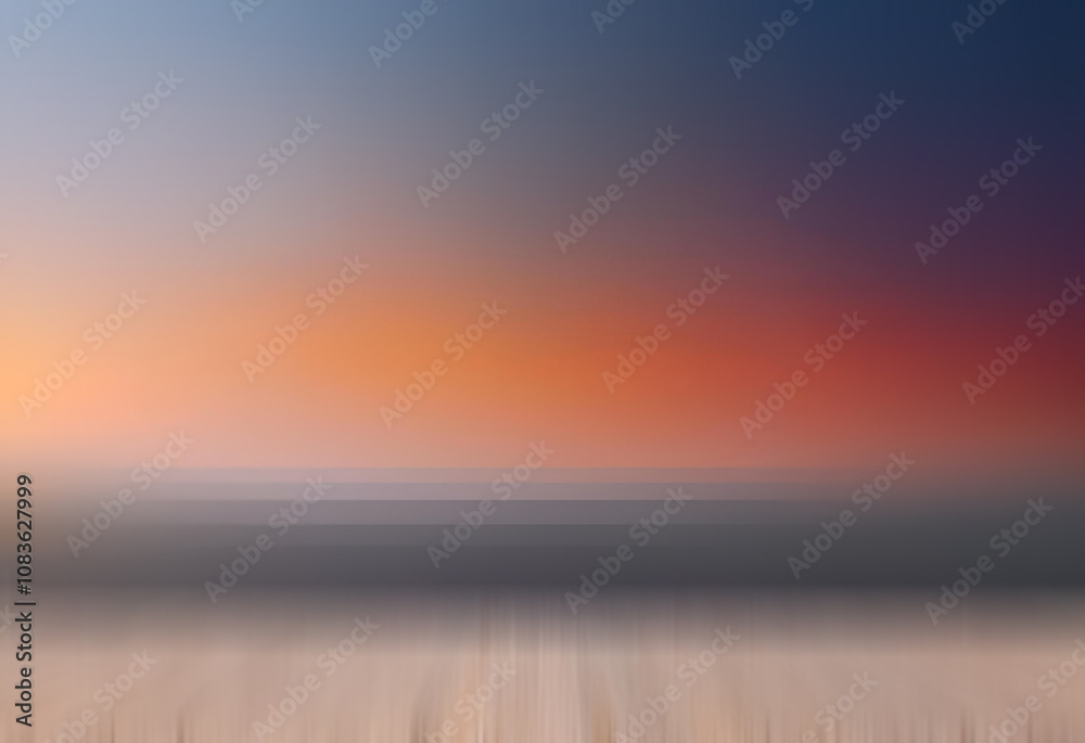 Poster Blurred sunset over a calm ocean, viewed from a low perspective.  The colors blend softly from cool blues and purples to warm oranges and reds.  A subtle wooden surface is visible in the foreground.