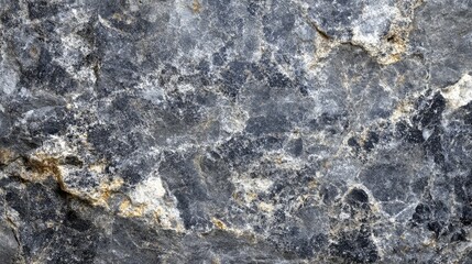 Close-Up View of Textured Natural Stone Surface Featuring Varied Shades of Gray, Black, and Gold Ideal for Backgrounds or Design Elements