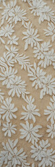 Vintage lace fabric in ivory with intricate floral patterns and delicate texture