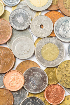 Background. Close-up. Various gold and silver coins on a bright background.