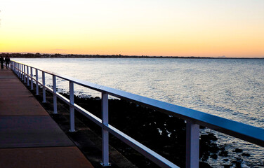 Sunset, purple and orange dawn sky at Shorncliffe pier, jetty, beach and bayside views, QLD