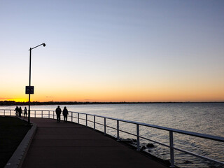 Obraz premium Sunset, purple and orange dawn sky at Shorncliffe pier, jetty, beach and bayside views, QLD