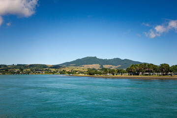 Fototapeta premium View over holiday park across sheltered bay at Tawatahi River. Raglan, New Zealand
