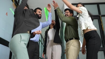 Group of young cheerful indian business people teaming up together and celebrating winning or success of company project. team spirit, bonding, corporate culture concept.